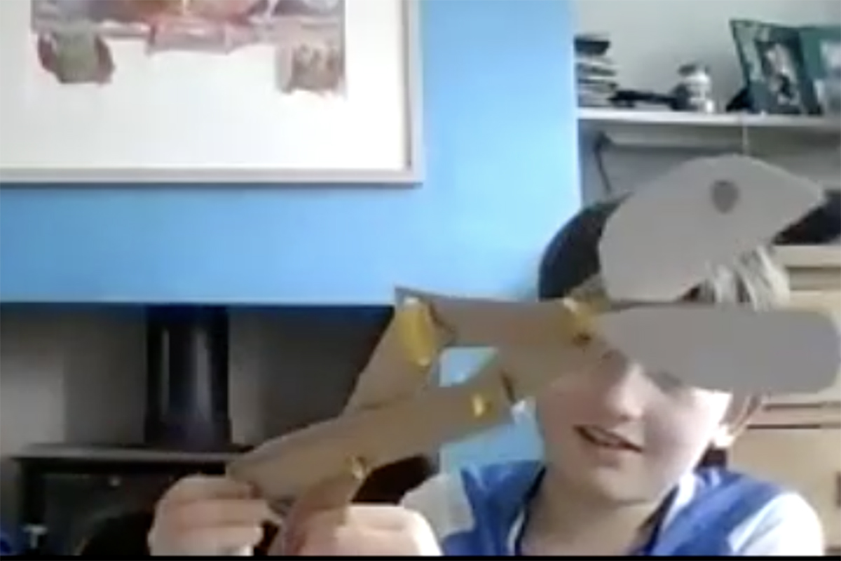 Boy holding scissor grabber with card hinges - Kids Own Reinvention project